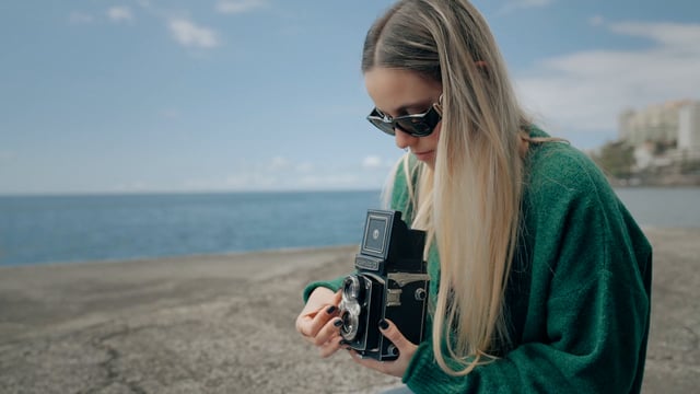 A young photographer uses a retro Yashica-D camera