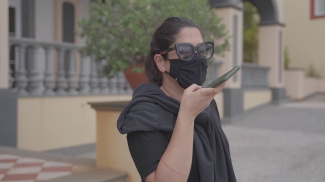 A woman recording a voice message on her smartphone