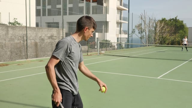 Man serving in a tennis match