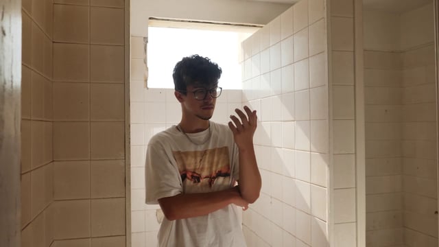Man standing in an empty bathroom
