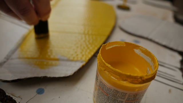 Painting cardboard shapes yellow