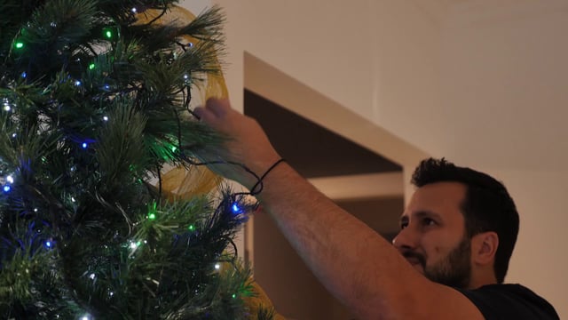 Man decorating a Christmas tree