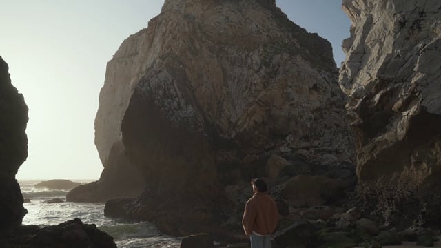 Traveler standing on a rocky beach