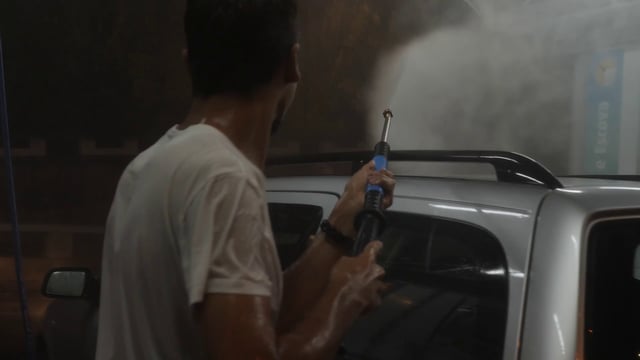 Man spraying water on a woman