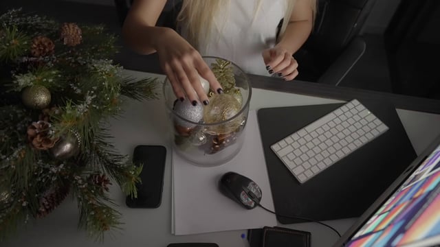 A girl looking at Christmas decorations while sitting at her desk