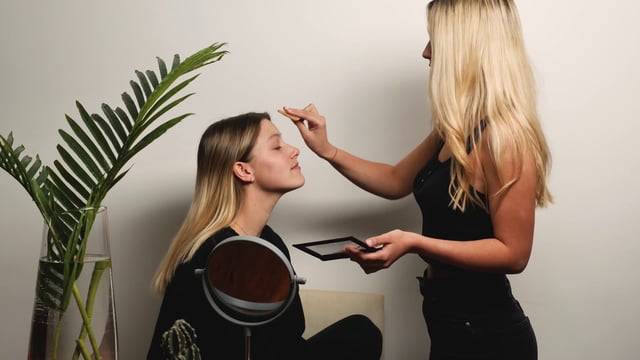 Makeup artist applying makeup