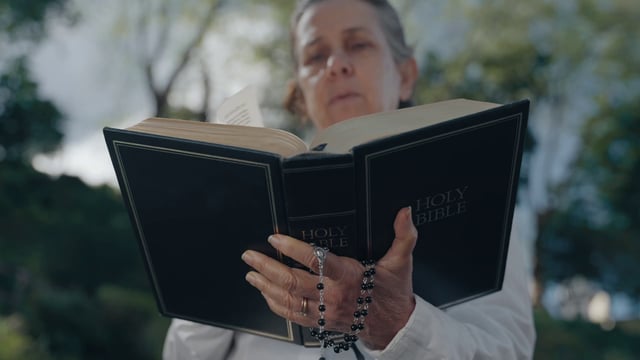 A religious woman reads a Holy Bible