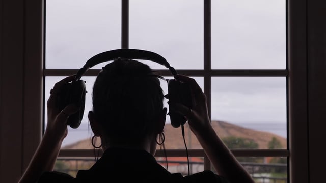 Woman putting on headphones