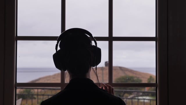 Listening to music by a window