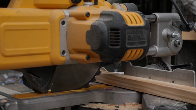 Cutting wood with electric saw 