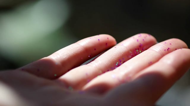 Glitter falling on someone's hands