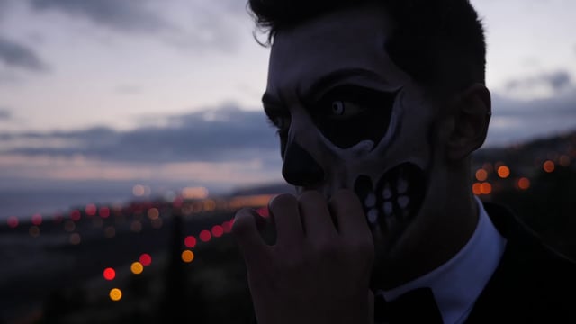 Man with Halloween makeup smoking