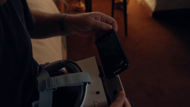 A man putting a smartphone into a VR headset