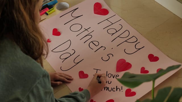 Girl creating a Mother's Day poster