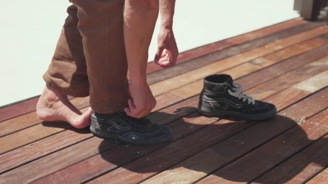 A guy taking off his shoes and socks
