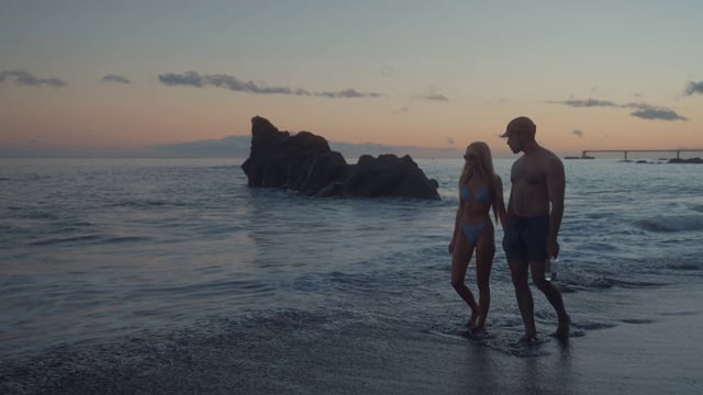 A couple walking by the coastline 