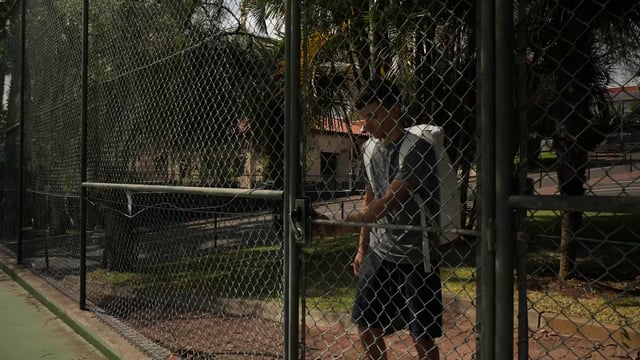 Man entering a tennis court