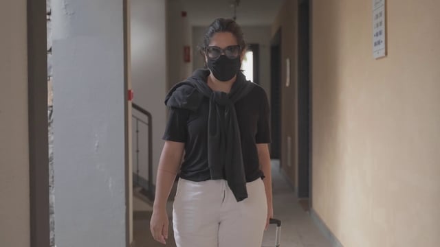 Medium shot of a tourist walking to a hotel room