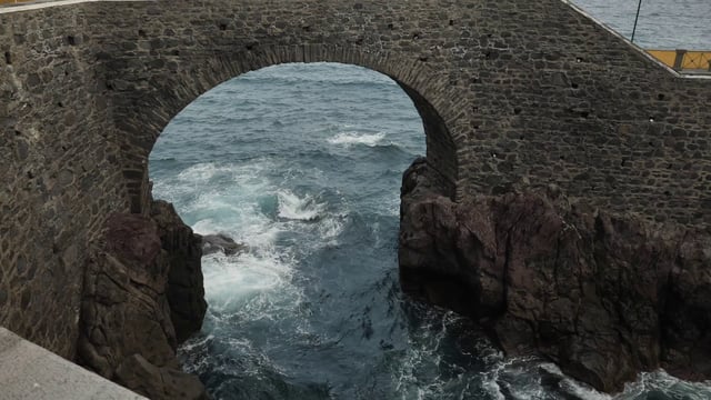Sea under a stone bridge
