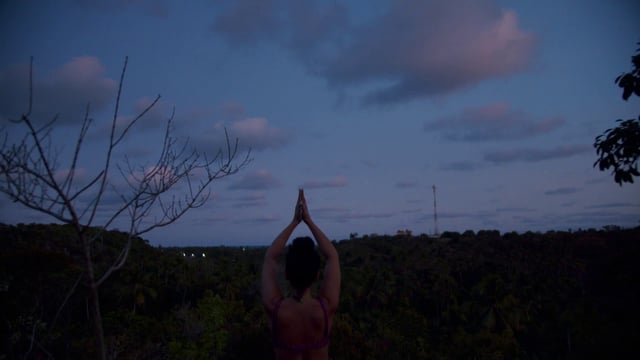 Woman doing yoga in the evening