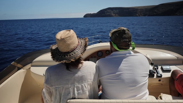 Couple driving a boat 