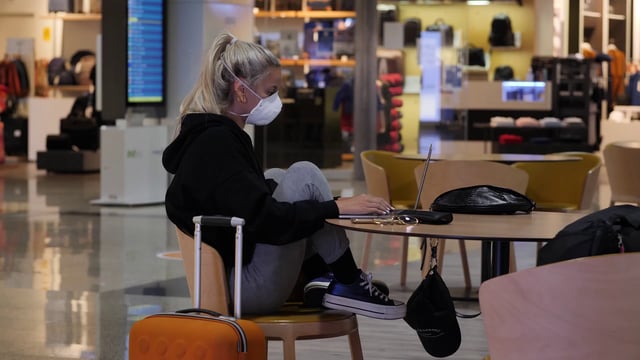 Woman uses laptop whilst at airport