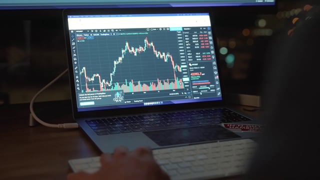 A businessman working on a stock market trading platform
