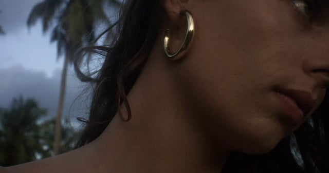 Woman wearing gold hoop earrings