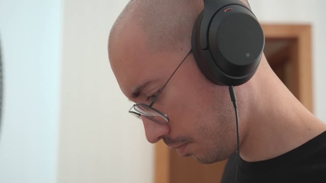 A guy reading lyrics while listening to music