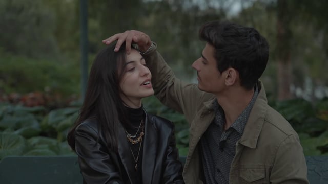 A guy gently stroking his girlfriend’s hair