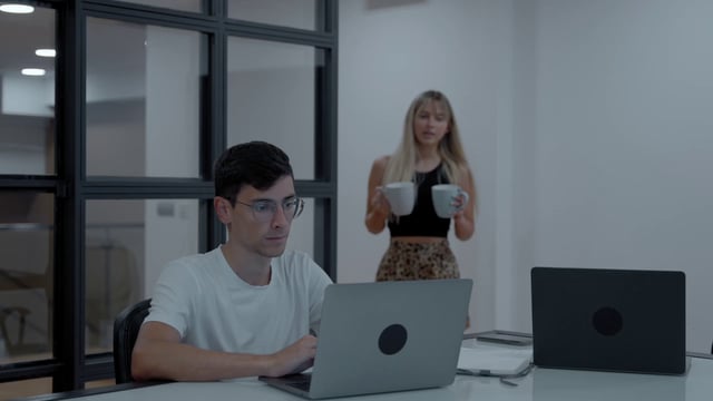  Colleagues working in the office while drinking coffee
