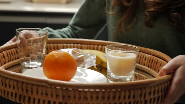 Girl carrying breakfast on a tray