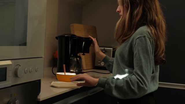 Girl putting a filter into the coffee machine