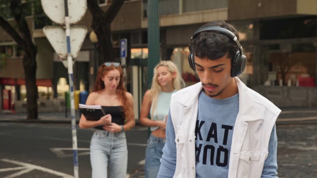 Boy with headphones walks to school