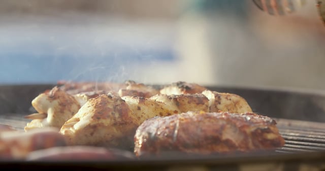 在烤架上翻转鸡肉