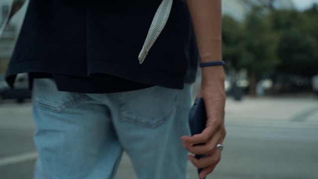 A guy walks with a smartphone