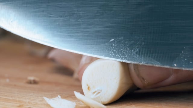 Slicing garlic with a knife
