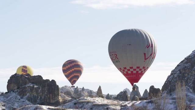 Hot air balloons near mountains