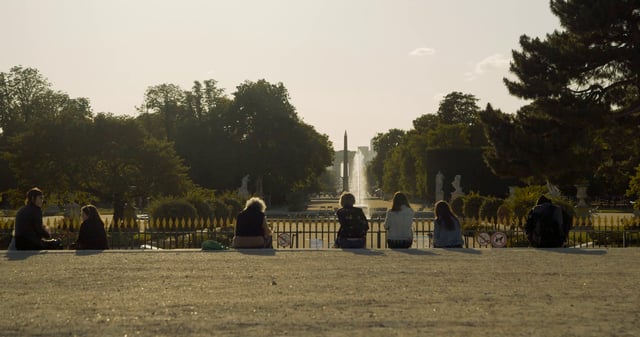 People talking near Louvre Fountain in Paris 