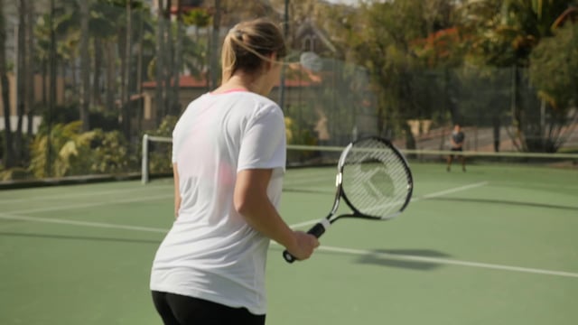 A woman serving during a tennis match