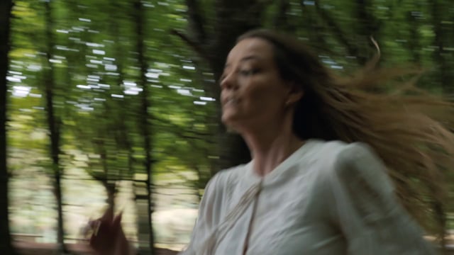 A woman running through a forest