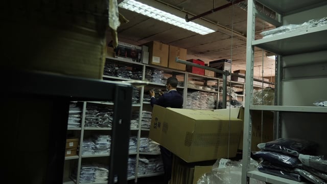 Store attendant in clothing warehouse