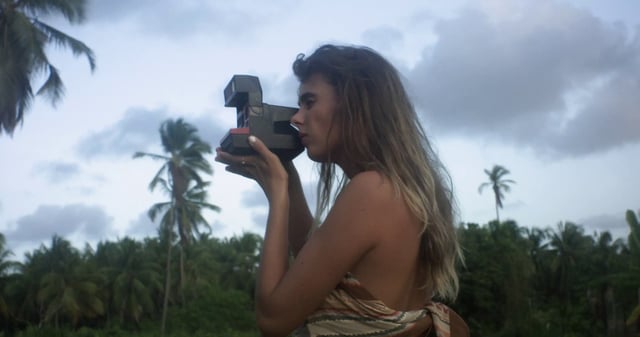 Woman taking photos with a Polaroid camera