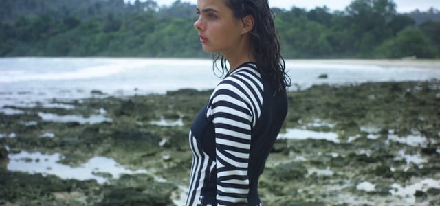 Surfer with wet hair posing