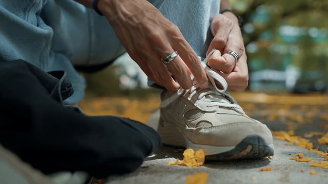 Close-up of a man tying his shoelaces