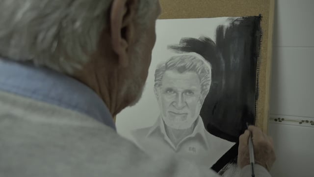 Old man painting a portrait
