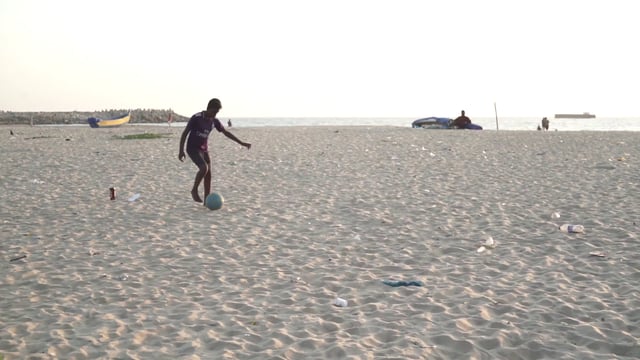 Playing football on the beach