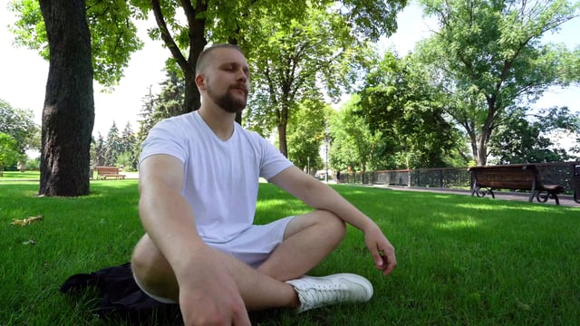Man meditating in the park 