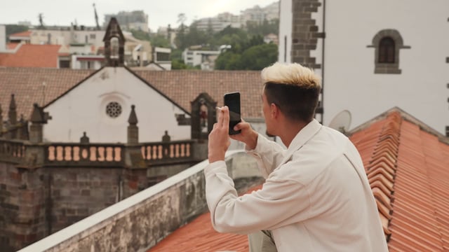 Man taking photos on rooftop
