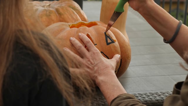 Carving an eye on a pumpkin